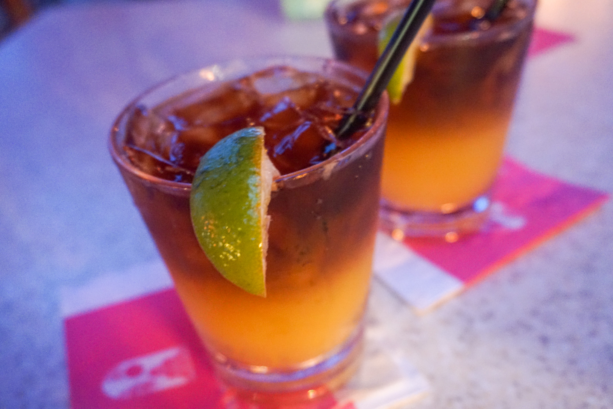 Two Mai Tais garnished with lime