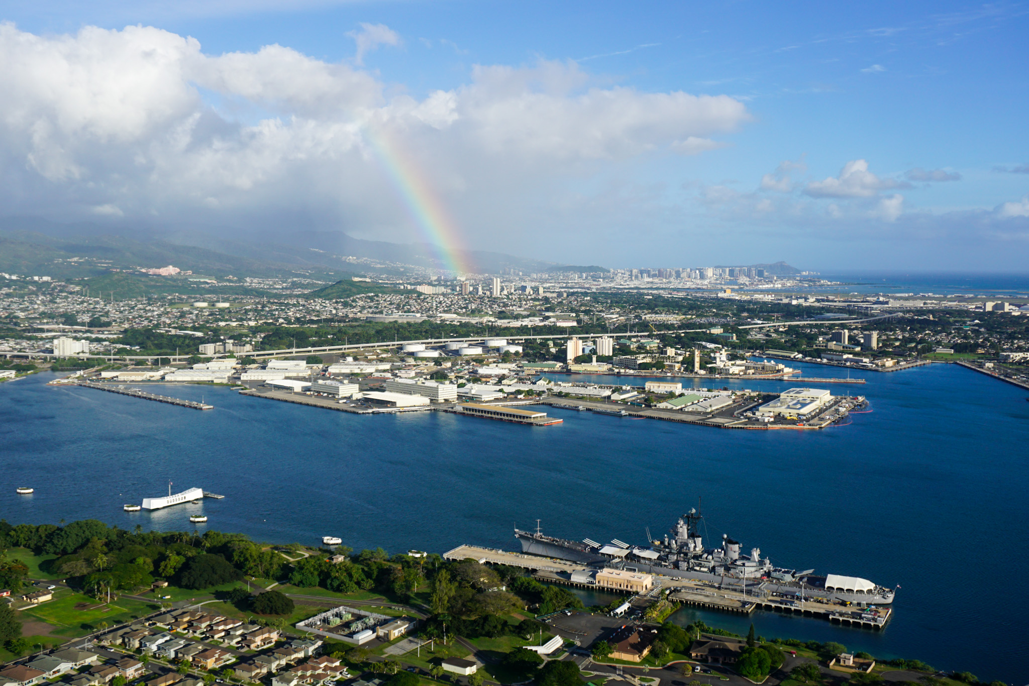 Aerial view of Pearl Harbor with rainbow in background