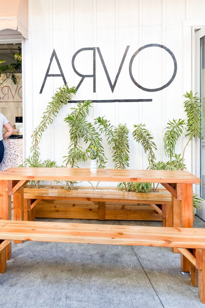 picnic tables outside in front of Arvo Cafe sign