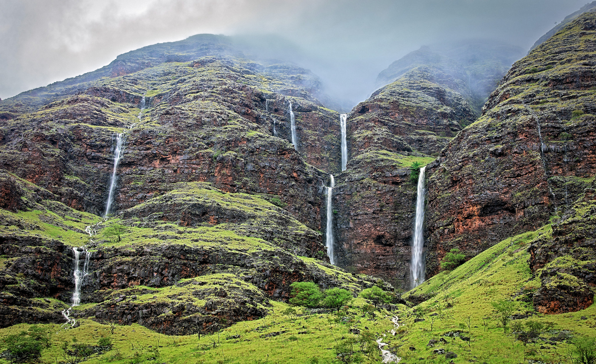 Cascading waterfalls in the green mountains of Makaha Valley