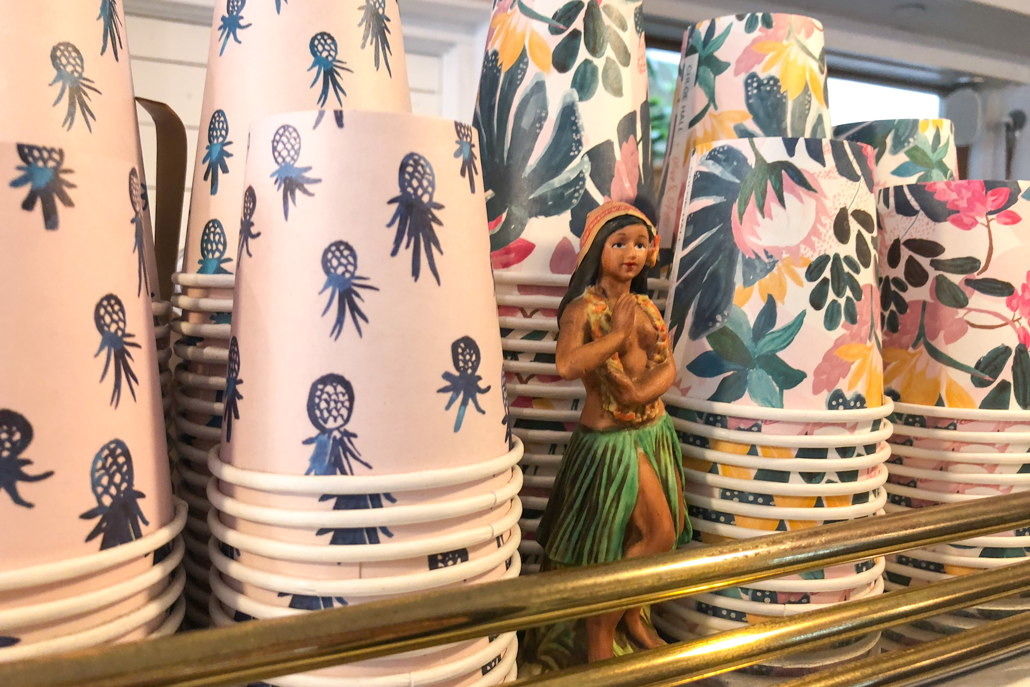 Colorful cups and hula girl figurine at Olive and Oliver Coffee Shop in Waikiki, Honolulu, Oahu, Hawaii