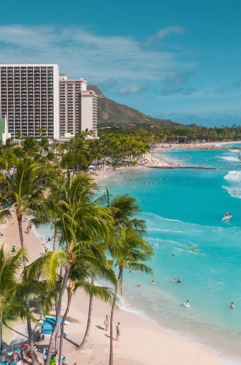View of Waikiki Beach and Diamond Head with people on sand and swimming in water - Honlulu, Oahu, Hawaii