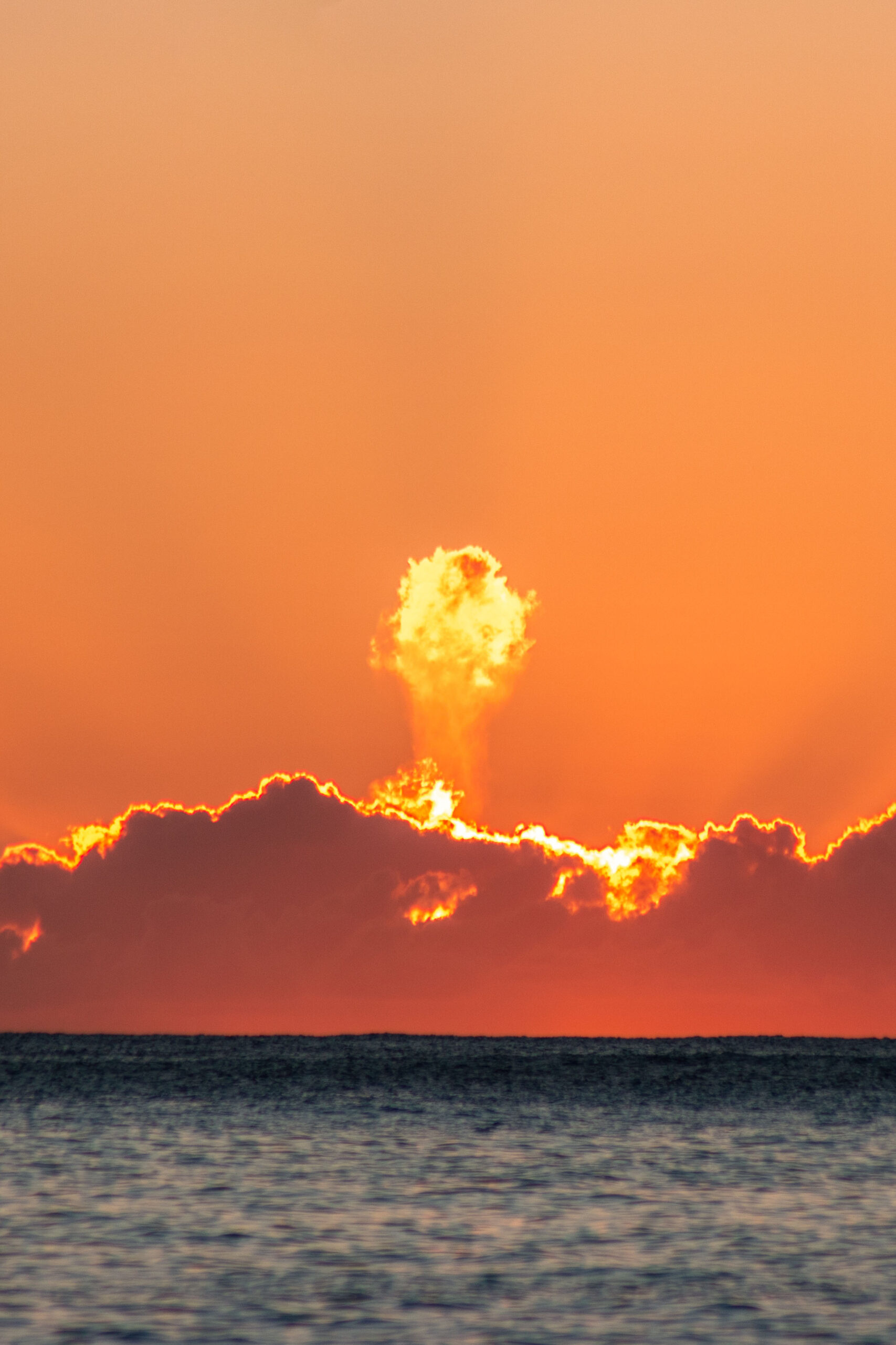 Bright orange sunset at Makaha Beach, Oahu, Hawaii